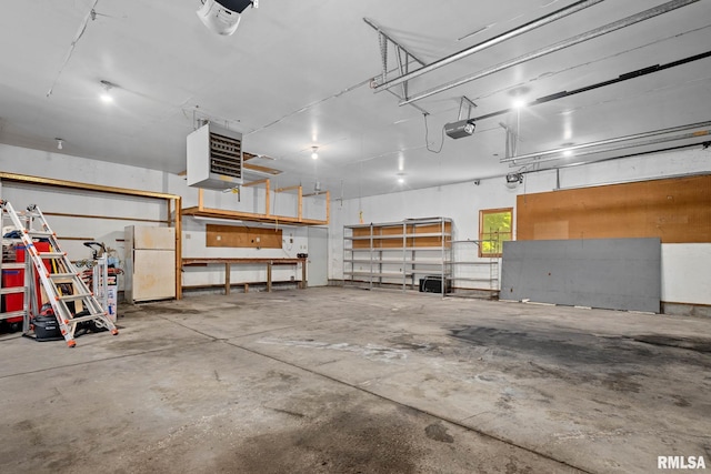 1426 N Main St, East Peoria, IL 61611 - garage featuring freestanding refrigerator, a garage door opener, and a heating unit