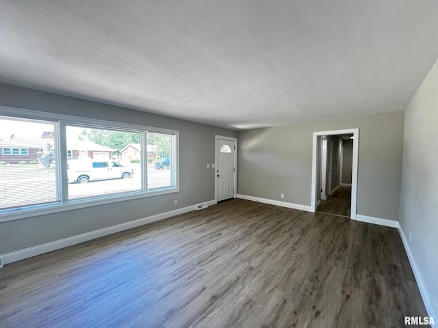 4914 N Bevalon Pl, Peoria, IL 61614 - unfurnished living room featuring wood finished floors and baseboards