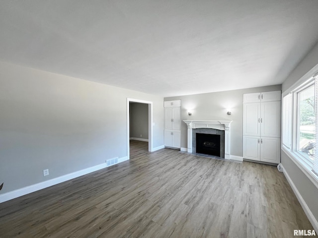 4914 N Bevalon Pl, Peoria, IL 61614 - unfurnished living room featuring wood finished floors and a fireplace