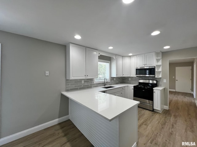 4914 N Bevalon Pl, Peoria, IL 61614 - kitchen featuring stainless steel appliances, open shelves, a peninsula, white cabinets, and recessed lighting