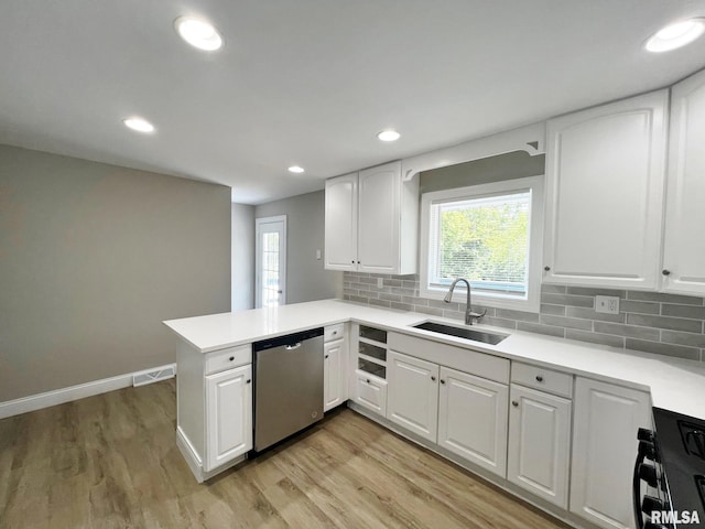 4914 N Bevalon Pl, Peoria, IL 61614 - kitchen featuring dishwasher, black gas stove, white cabinetry, light countertops, and a peninsula