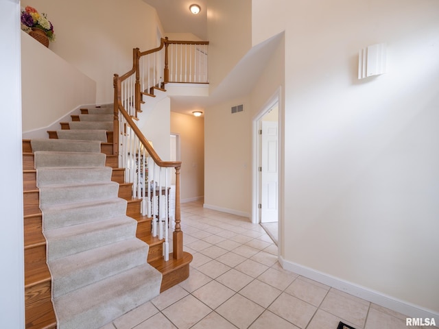 919 W Brookforest Dr, Peoria, IL 61615 - stairs featuring tile patterned floors and a high ceiling
