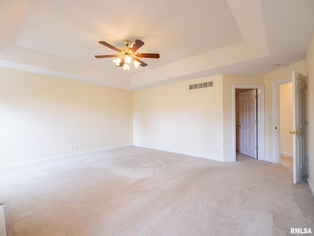 919 W Brookforest Dr, Peoria, IL 61615 - empty room with a tray ceiling, a ceiling fan, and light colored carpet