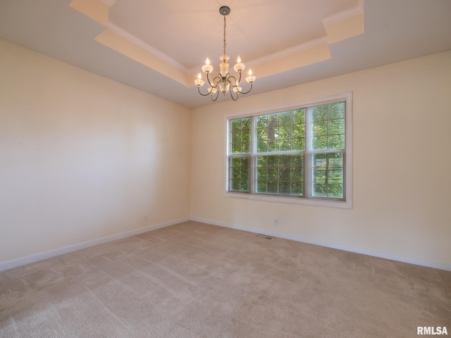 919 W Brookforest Dr, Peoria, IL 61615 - spare room with a tray ceiling, light colored carpet, a chandelier, and crown molding