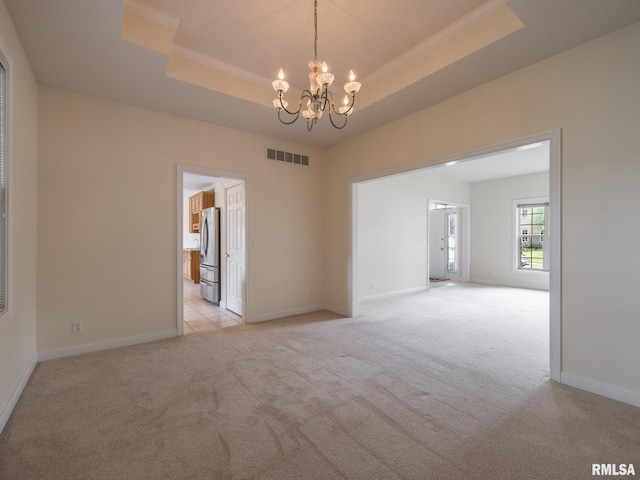 919 W Brookforest Dr, Peoria, IL 61615 - empty room featuring a raised ceiling, light carpet, a chandelier, and ornamental molding