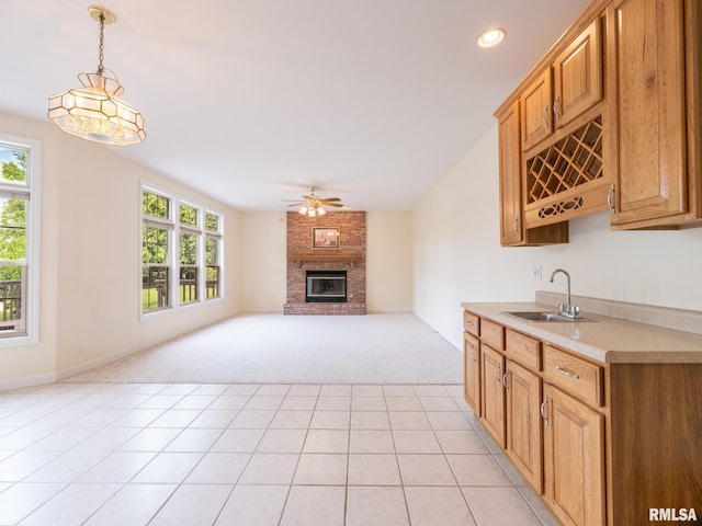 919 W Brookforest Dr, Peoria, IL 61615 - kitchen featuring light colored carpet, light countertops, healthy amount of natural light, a brick fireplace, and recessed lighting