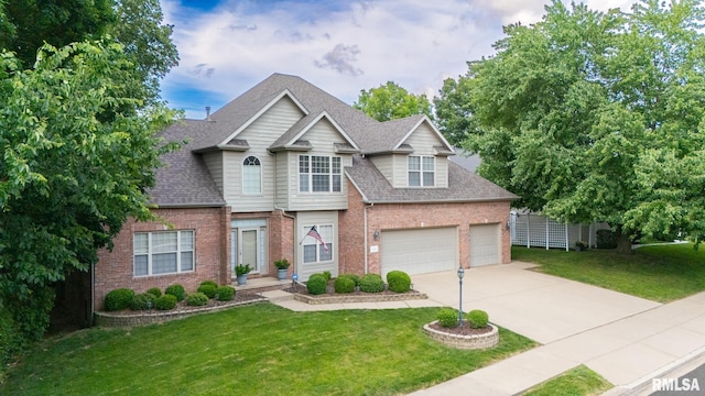 919 W Brookforest Dr, Peoria, IL 61615 - view of front facade featuring brick siding, driveway, roof with shingles, and a front lawn