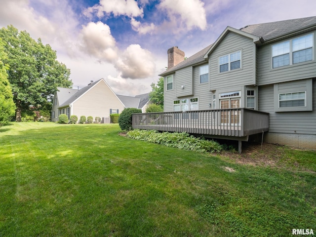 919 W Brookforest Dr, Peoria, IL 61615 - back of house with a chimney, a wooden deck, and a yard