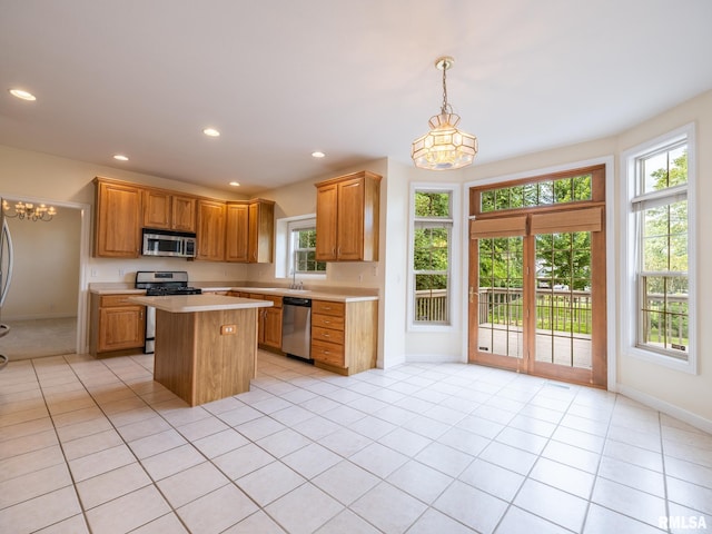 919 W Brookforest Dr, Peoria, IL 61615 - kitchen featuring stainless steel appliances, a chandelier, light countertops, a kitchen island, and light tile patterned flooring