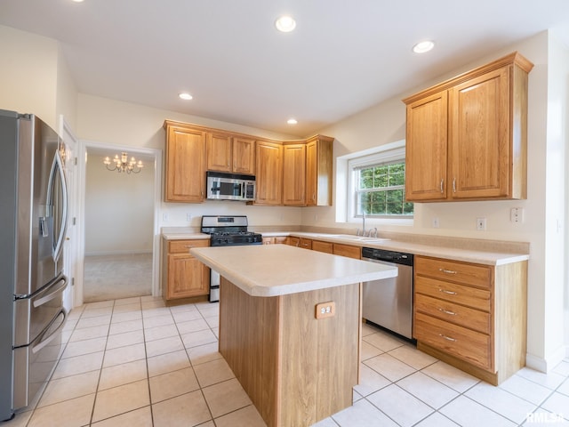 919 W Brookforest Dr, Peoria, IL 61615 - kitchen with appliances with stainless steel finishes, light countertops, a center island, a chandelier, and light tile patterned flooring