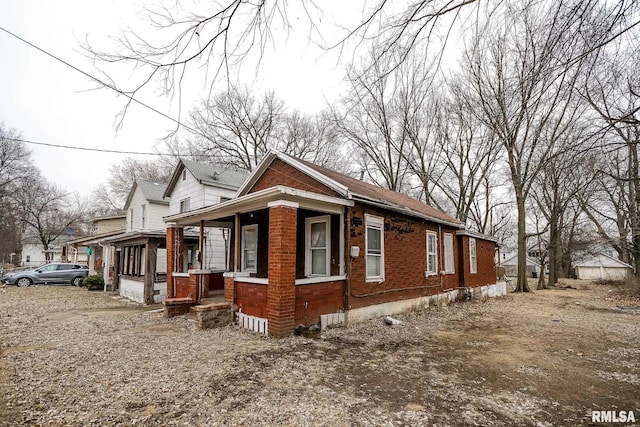 1710 NE Madison Ave, Peoria, IL 61603 - view of property exterior with covered porch and brick siding