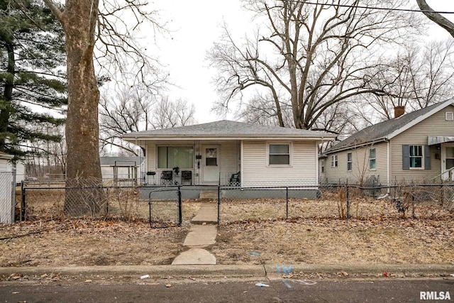 1831 S Kneer Ave, Peoria, IL 61605 - view of front of property featuring covered porch, a fenced front yard, and roof with shingles