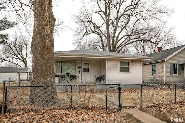 1831 S Kneer Ave, Peoria, IL 61605 - view of front of home featuring a porch, a fenced front yard, and a gate