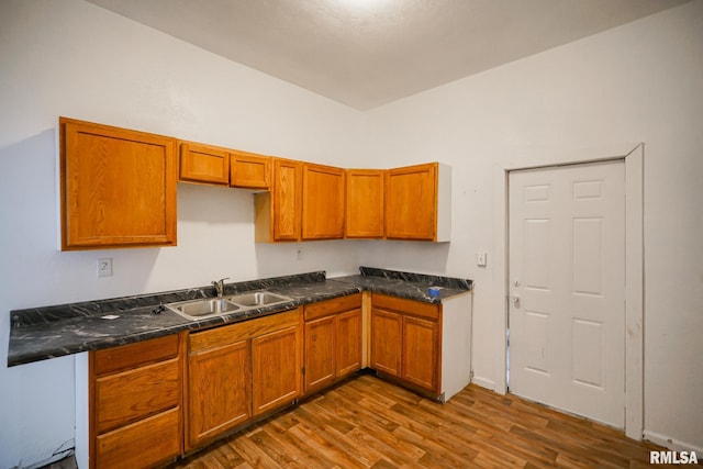 506 Spring St, Peoria, IL 61603 - kitchen featuring dark wood-style floors, brown cabinetry, and dark countertops