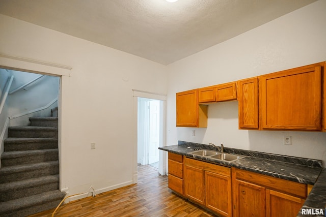 506 Spring St, Peoria, IL 61603 - kitchen featuring light wood-style floors, dark countertops, and brown cabinets