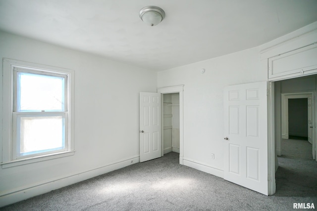 506 Spring St, Peoria, IL 61603 - unfurnished bedroom featuring carpet, multiple windows, and a closet