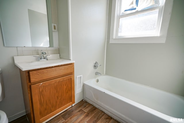 506 Spring St, Peoria, IL 61603 - full bath featuring vanity, wood finished floors, backsplash, and bathing tub / shower combination