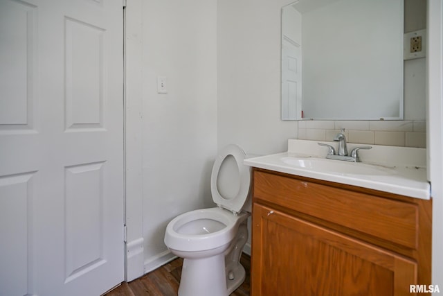 506 Spring St, Peoria, IL 61603 - bathroom featuring vanity, backsplash, and wood finished floors