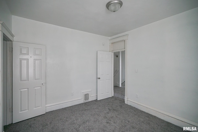 506 Spring St, Peoria, IL 61603 - unfurnished bedroom with carpet floors and baseboards