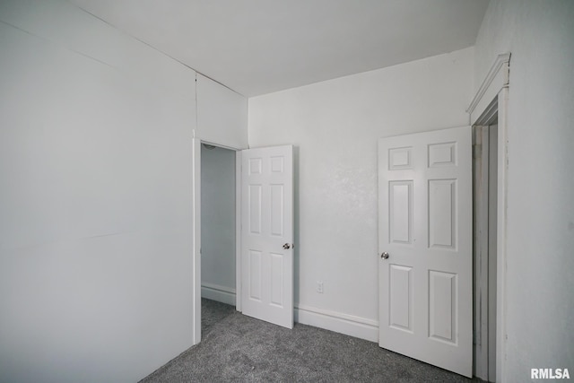 506 Spring St, Peoria, IL 61603 - unfurnished bedroom featuring dark colored carpet