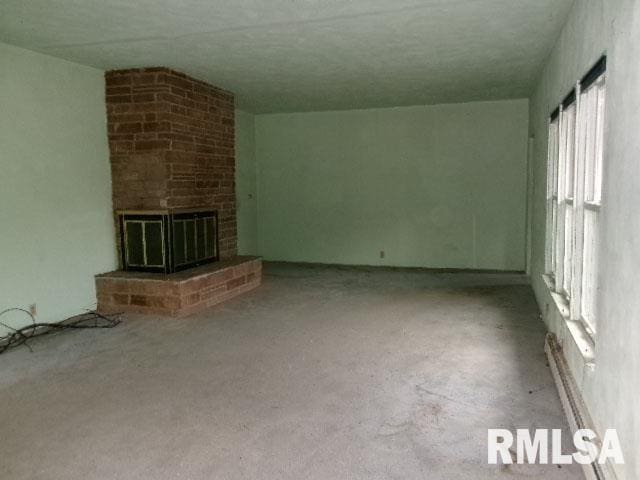 215 N Prairie St, Lacon, IL 61540 - unfurnished living room featuring a brick fireplace