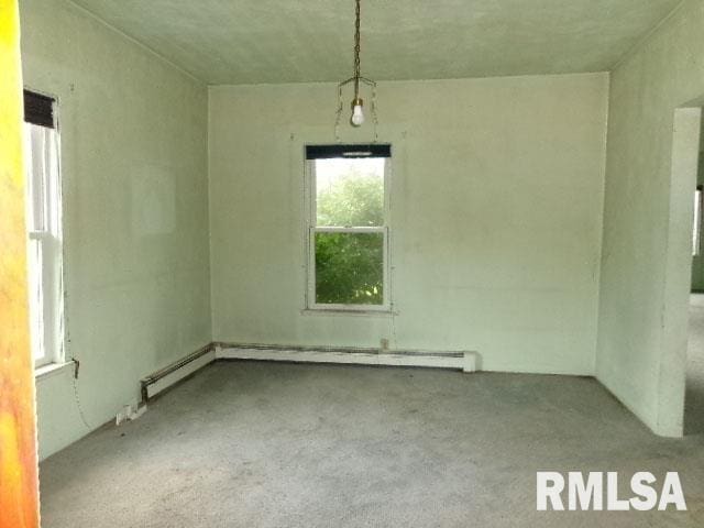 215 N Prairie St, Lacon, IL 61540 - empty room featuring carpet and a baseboard heating unit