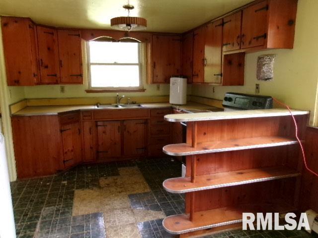215 N Prairie St, Lacon, IL 61540 - kitchen with brown cabinetry, tile patterned floors, and light countertops