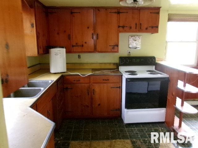 215 N Prairie St, Lacon, IL 61540 - kitchen with white electric range oven and brown cabinetry