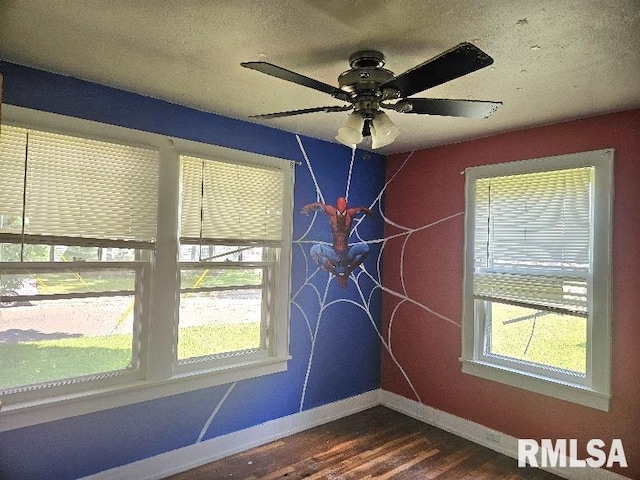 246 E Myrtle St, Canton, IL 61520 - spare room featuring dark wood-style floors, healthy amount of natural light, ceiling fan, and a textured ceiling