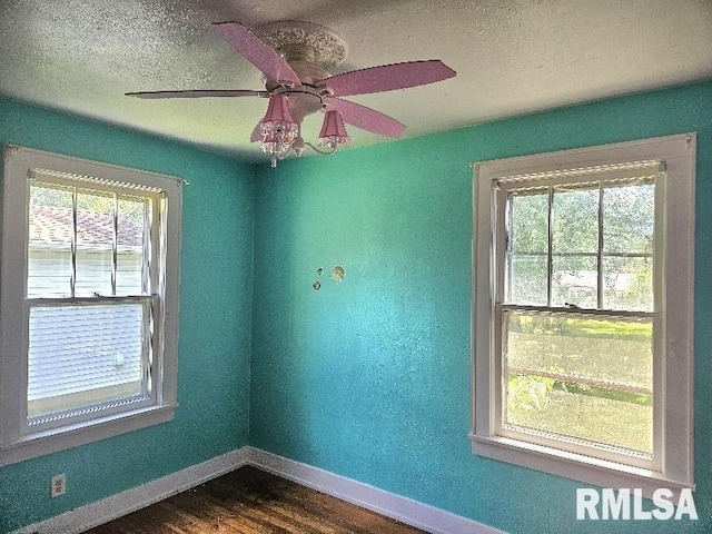 246 E Myrtle St, Canton, IL 61520 - empty room with dark wood finished floors, a textured ceiling, and ceiling fan