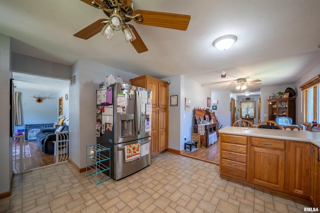 611 E Ash St, Canton, IL 61520 - kitchen with stainless steel fridge, a ceiling fan, brick patterned floors, and light countertops