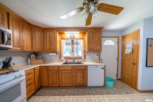611 E Ash St, Canton, IL 61520 - kitchen featuring white appliances, brown cabinetry, light countertops, ceiling fan, and brick patterned flooring