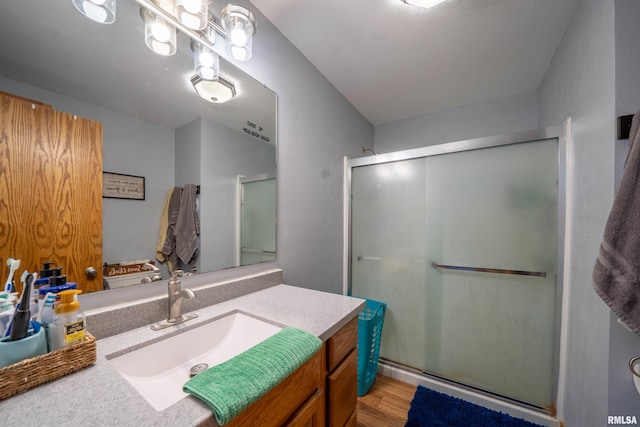 611 E Ash St, Canton, IL 61520 - full bath with vanity, a stall shower, and wood finished floors