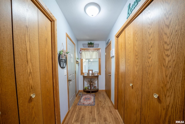 611 E Ash St, Canton, IL 61520 - hallway featuring light wood-style floors and baseboards