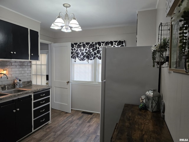 270 Thompson Ct, Canton, IL 61520 - kitchen featuring dark cabinetry, dark countertops, tasteful backsplash, a chandelier, and dark wood-type flooring
