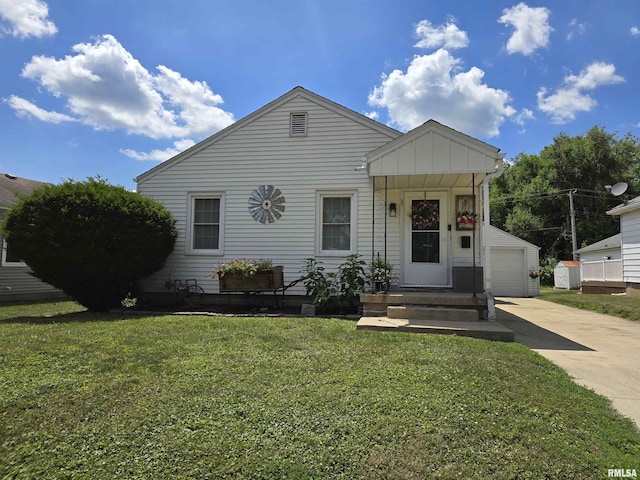 270 Thompson Ct, Canton, IL 61520 - view of front of property featuring board and batten siding, an outbuilding, a front lawn, concrete driveway, and a garage