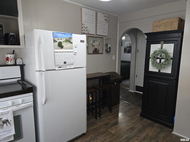 270 Thompson Ct, Canton, IL 61520 - kitchen with freestanding refrigerator, wall oven, dark wood-style flooring, and arched walkways