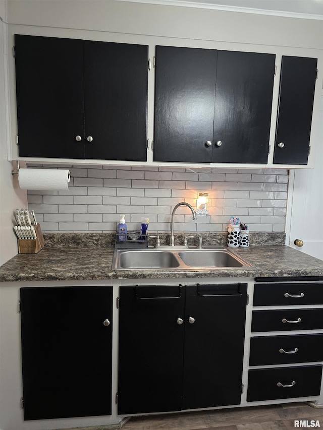 270 Thompson Ct, Canton, IL 61520 - kitchen featuring dark cabinetry, tasteful backsplash, dark countertops, and wood finished floors