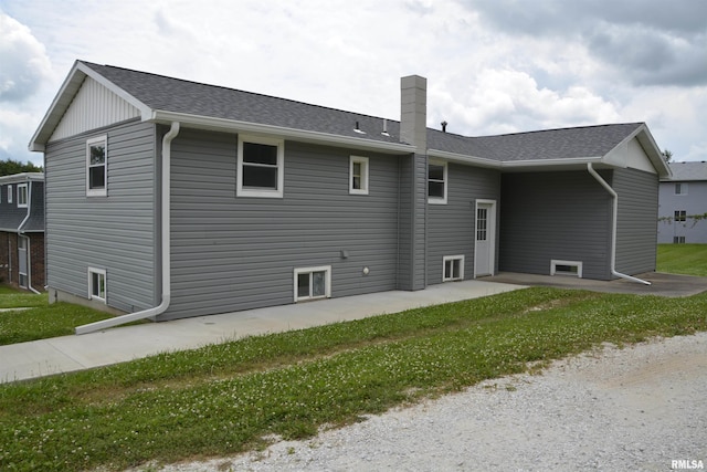 926 N Charles St, Macomb, IL 61455 - rear view of house with a chimney, a patio, and roof with shingles