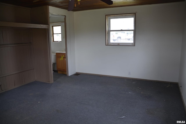 926 N Charles St, Macomb, IL 61455 - unfurnished bedroom with wood ceiling, carpet floors, and connected bathroom