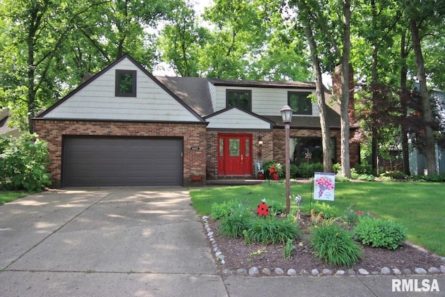1402 W Grandridge Dr, Dunlap, IL 61525 - view of front facade featuring concrete driveway, a front yard, brick siding, and a garage