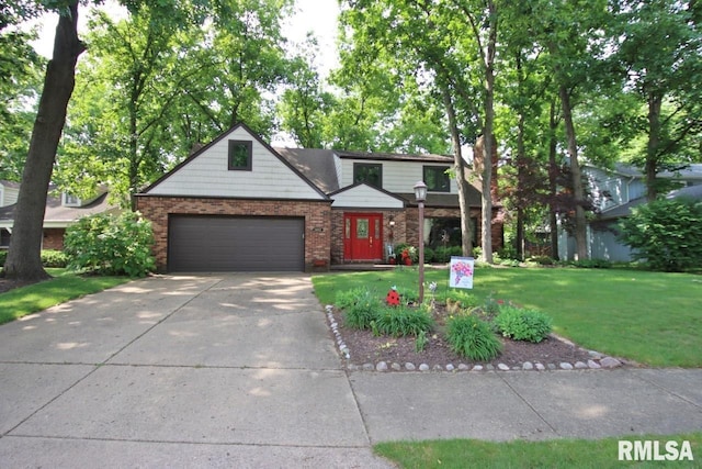 1402 W Grandridge Dr, Dunlap, IL 61525 - view of front of home with a front yard, concrete driveway, a garage, and brick siding