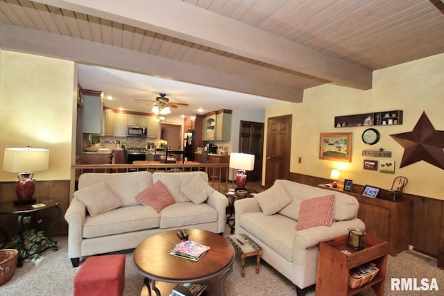 1402 W Grandridge Dr, Dunlap, IL 61525 - carpeted living room featuring wainscoting, a wooden ceiling with exposed beams, ceiling fan, and wooden walls