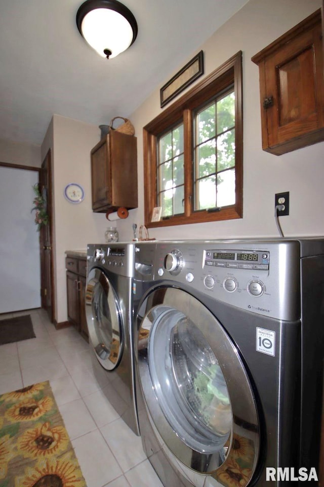 1402 W Grandridge Dr, Dunlap, IL 61525 - laundry area featuring cabinet space, washing machine and clothes dryer, and light tile patterned floors