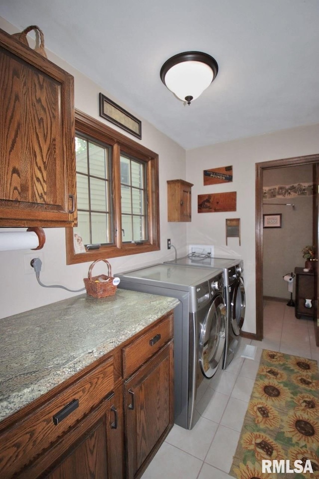 1402 W Grandridge Dr, Dunlap, IL 61525 - laundry room featuring cabinet space, washing machine and clothes dryer, and light tile patterned flooring