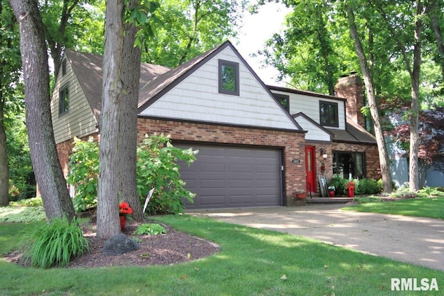 1402 W Grandridge Dr, Dunlap, IL 61525 - view of front of home with brick siding, concrete driveway, and a chimney