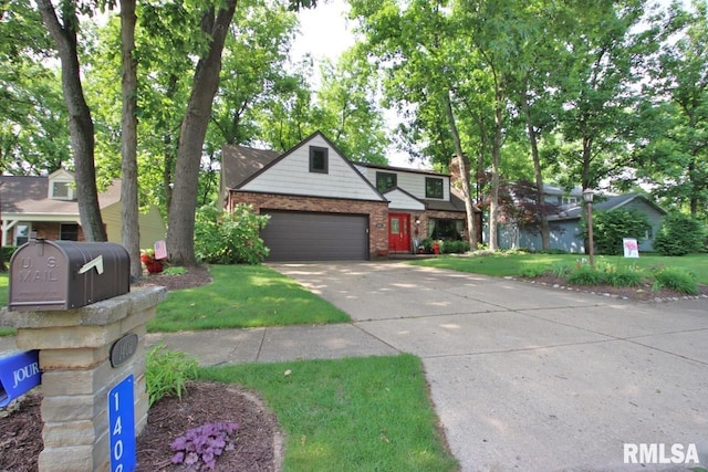 1402 W Grandridge Dr, Dunlap, IL 61525 - traditional-style home featuring brick siding, driveway, a front lawn, and a garage