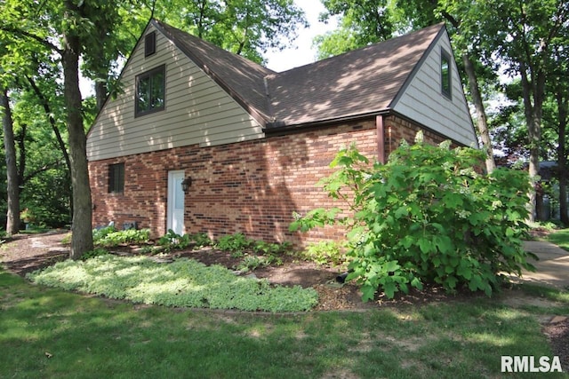 1402 W Grandridge Dr, Dunlap, IL 61525 - view of property exterior featuring brick siding and a shingled roof