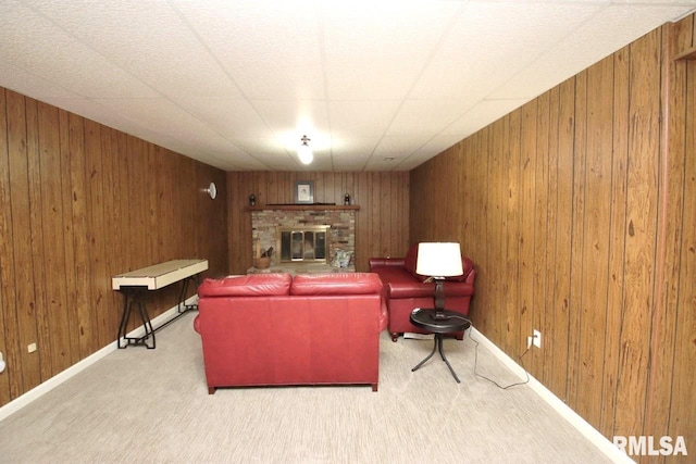 1402 W Grandridge Dr, Dunlap, IL 61525 - living room featuring wood walls, carpet flooring, and a brick fireplace