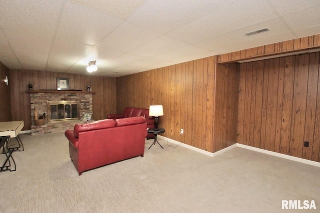 1402 W Grandridge Dr, Dunlap, IL 61525 - carpeted living area with a fireplace, wooden walls, and a drop ceiling